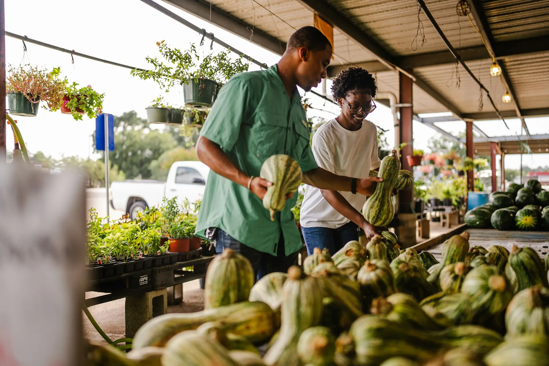 Couple shopping for gourds at an outdoor market.